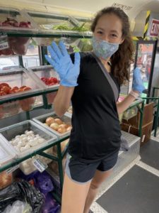 An intern works on a Boston Fresh Truck to help out during advocacy afternoon, helping to support local communities. The intern came prepared with a mask and gloves on.